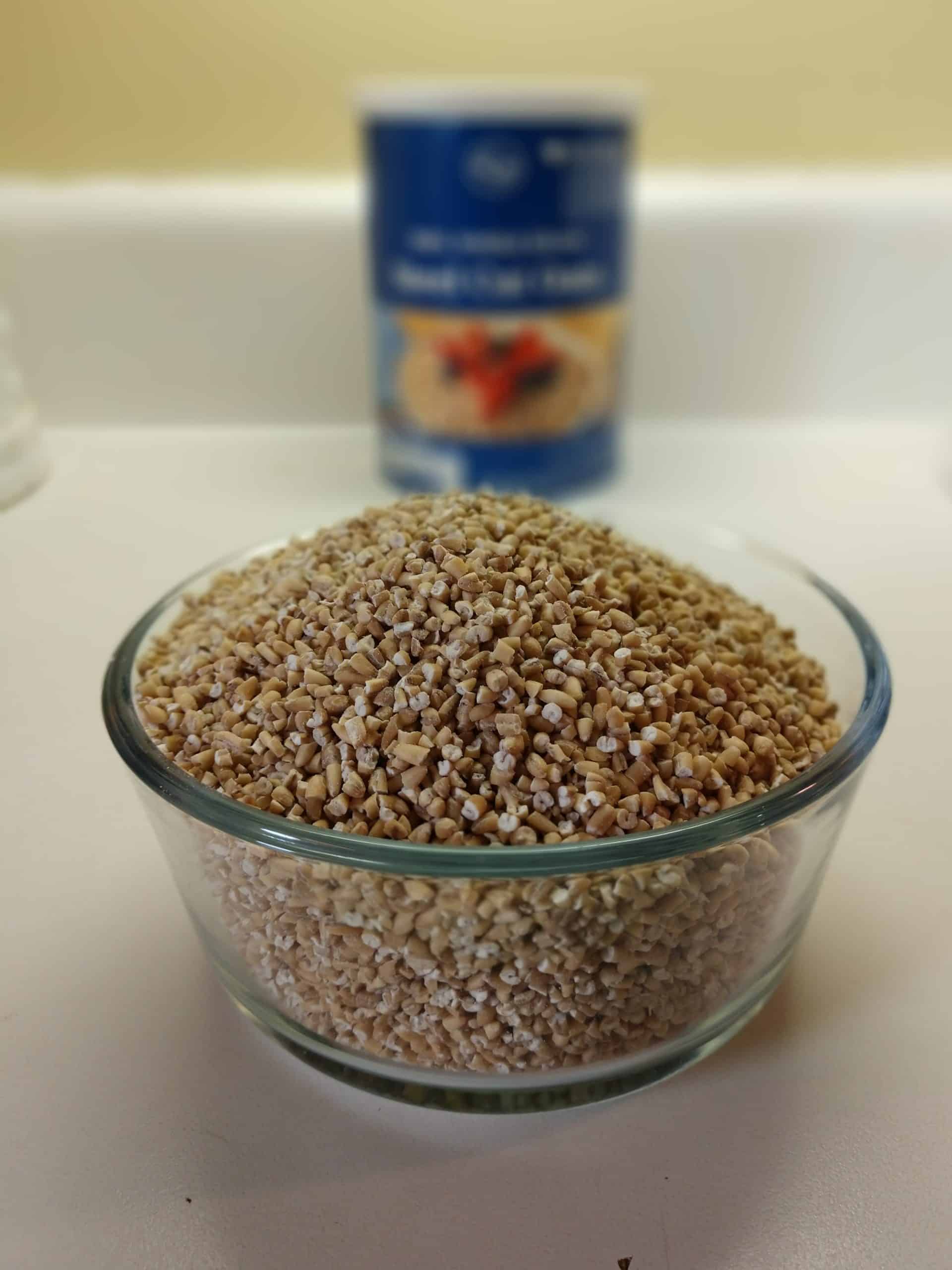 bowl of precooked steel cut oats with steel cut oats container in the background
