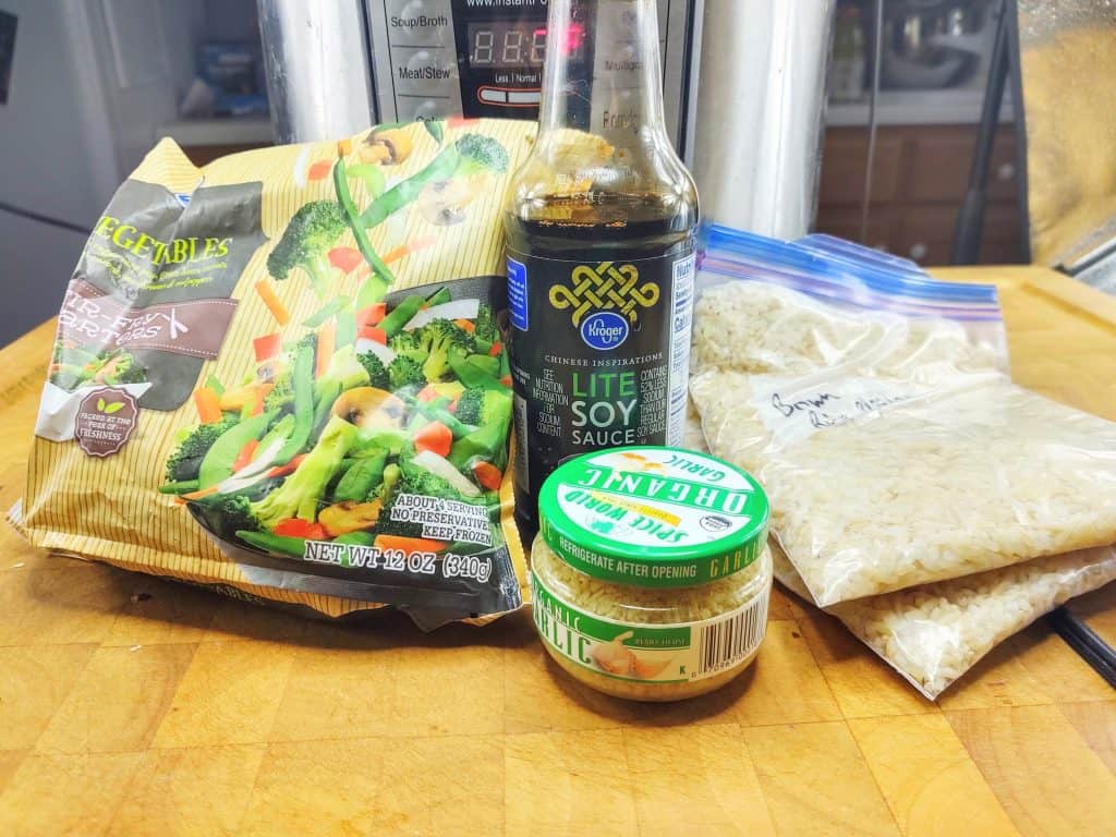 instant pot, bag of frozen stir fry mix, minced garlic, bottle of lite soy sauce, 2 bags of cooked rice