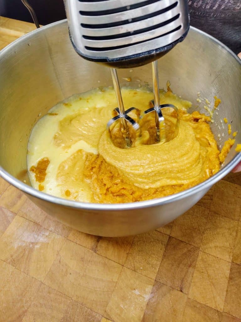 mixing pumpkin into sugar/butter mix