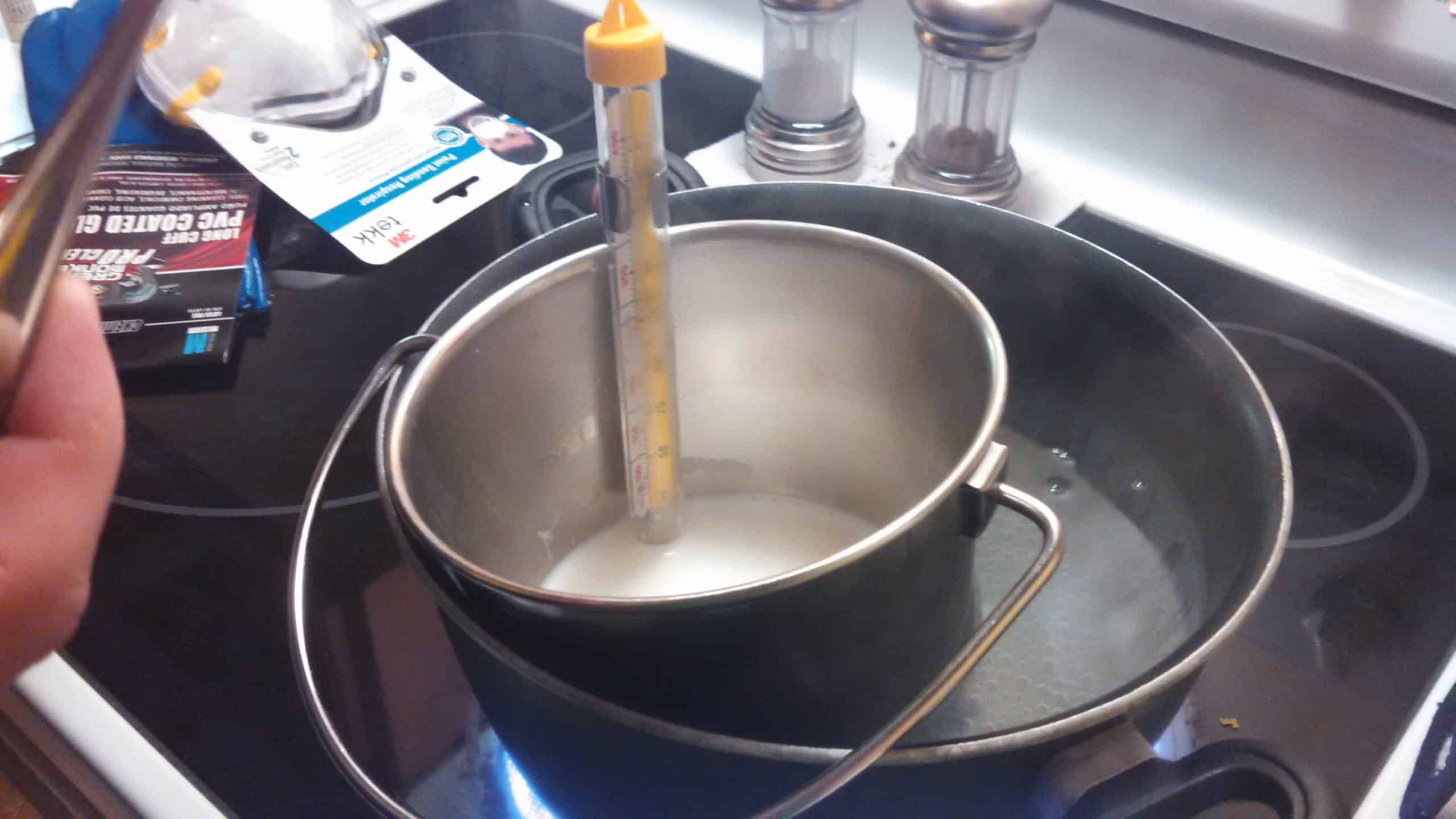 milk bucket in larger pot of boiling water