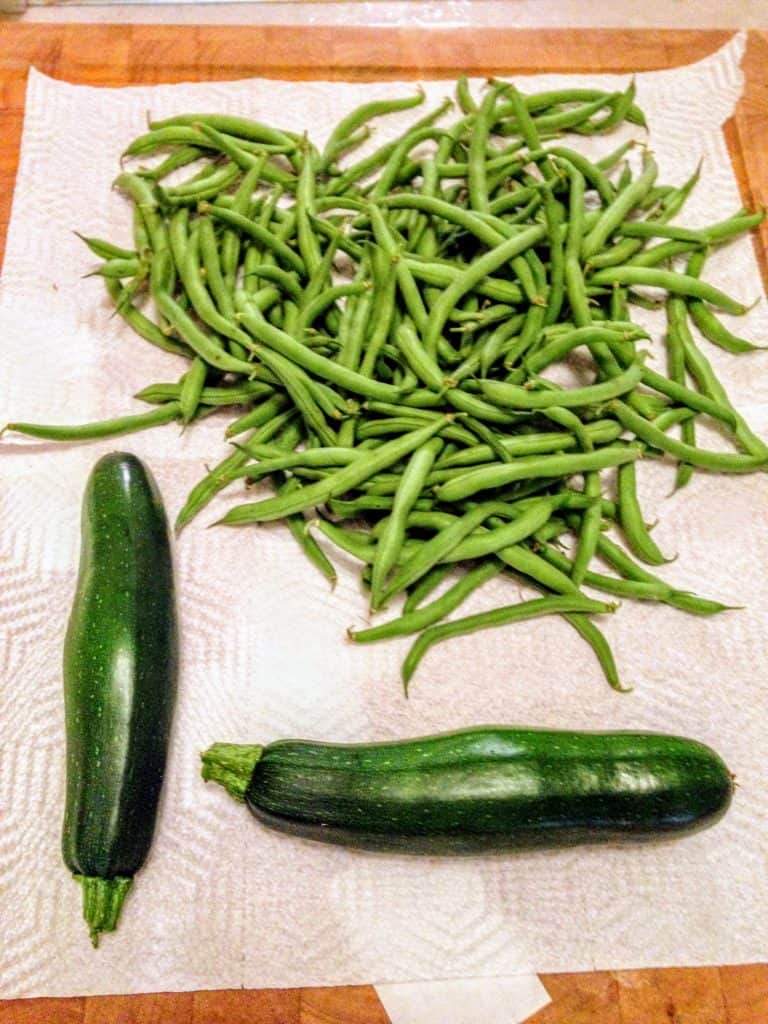green beans and zucchini sitting on counter