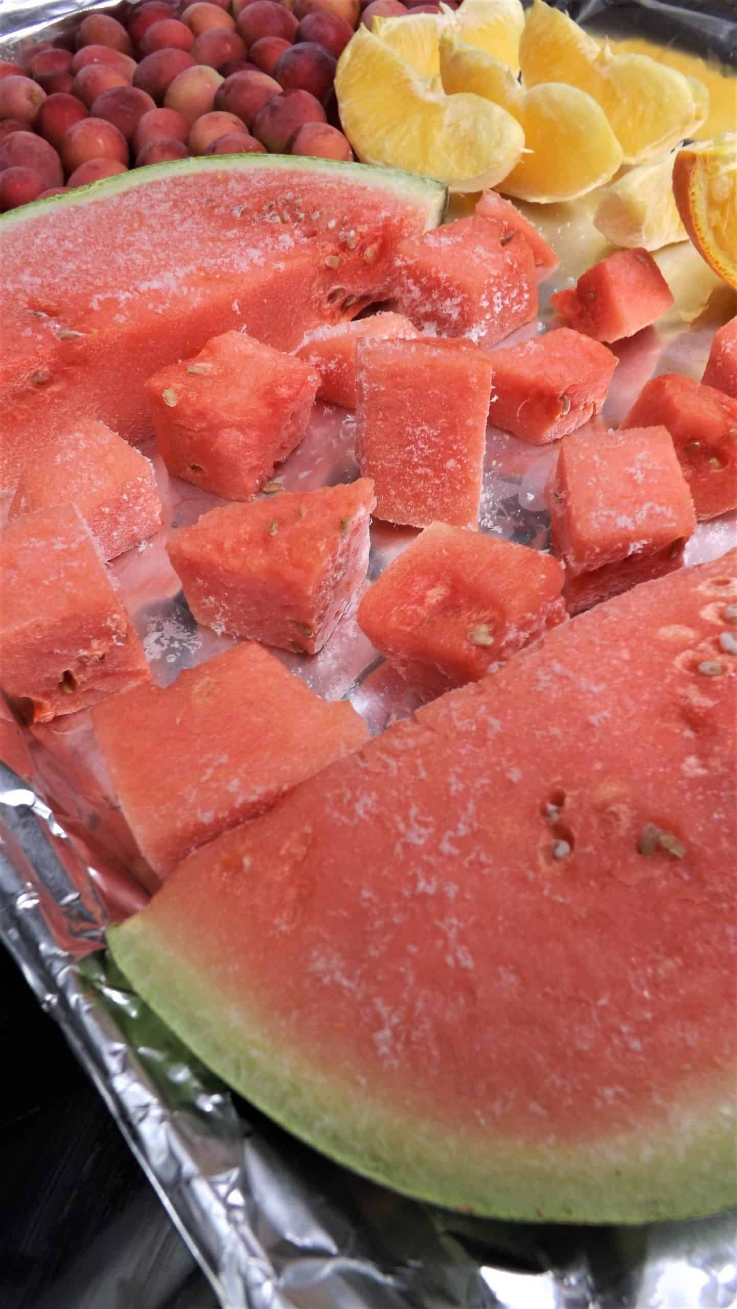 frozen watermelon on baking pan wrapped in foil