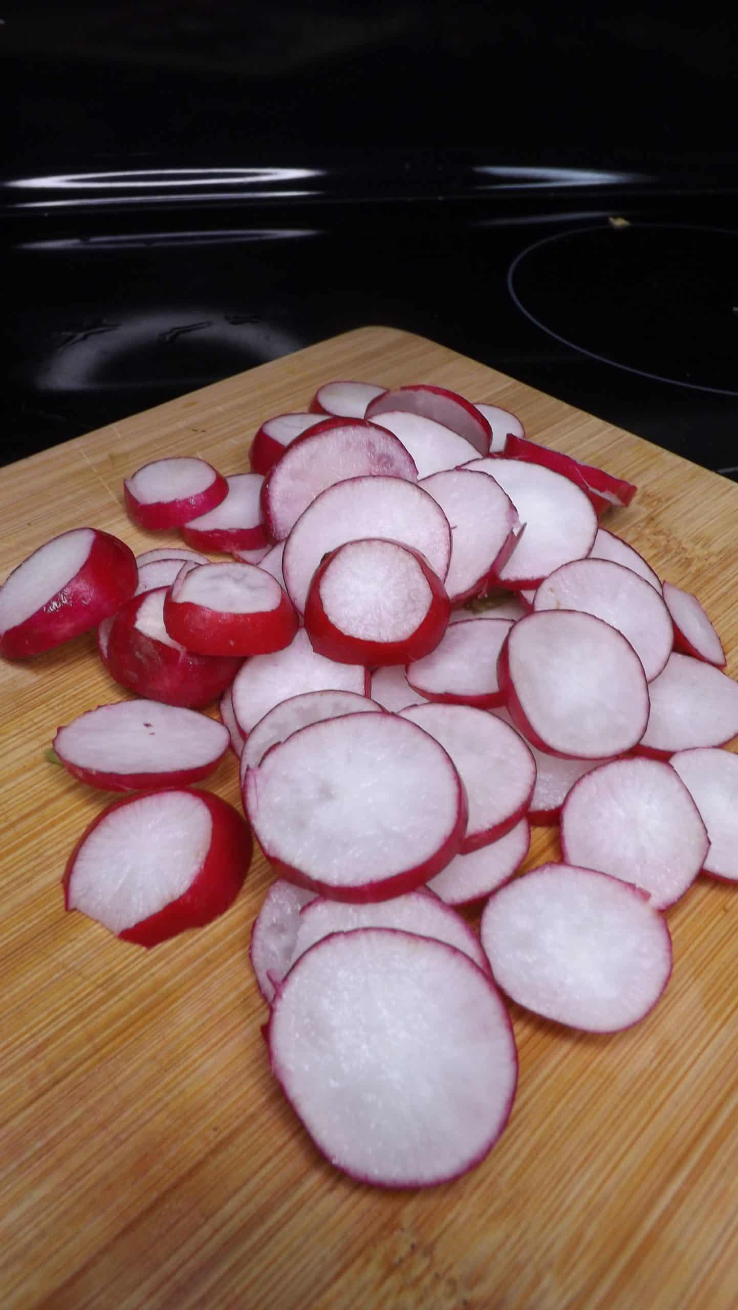 fresh cut radishes on cutting board