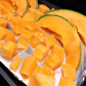 frozen cantaloupe on baking pan wrapped in foil
