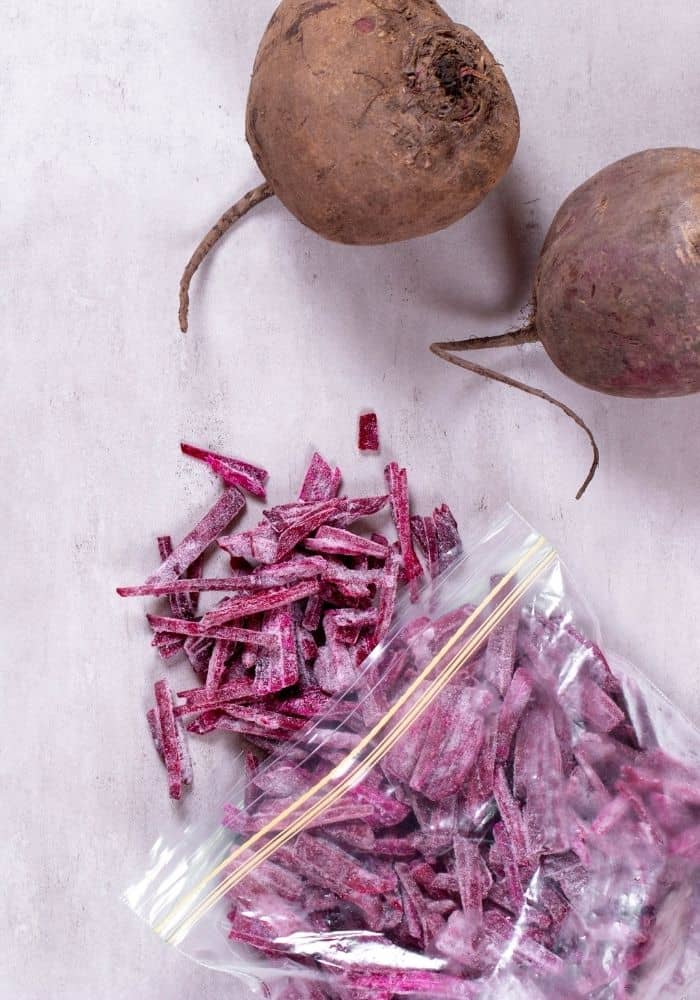 two beets and frozen shredded beets in a bag.