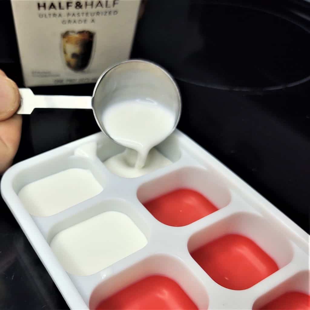half and half being poured into an ice cube tray
