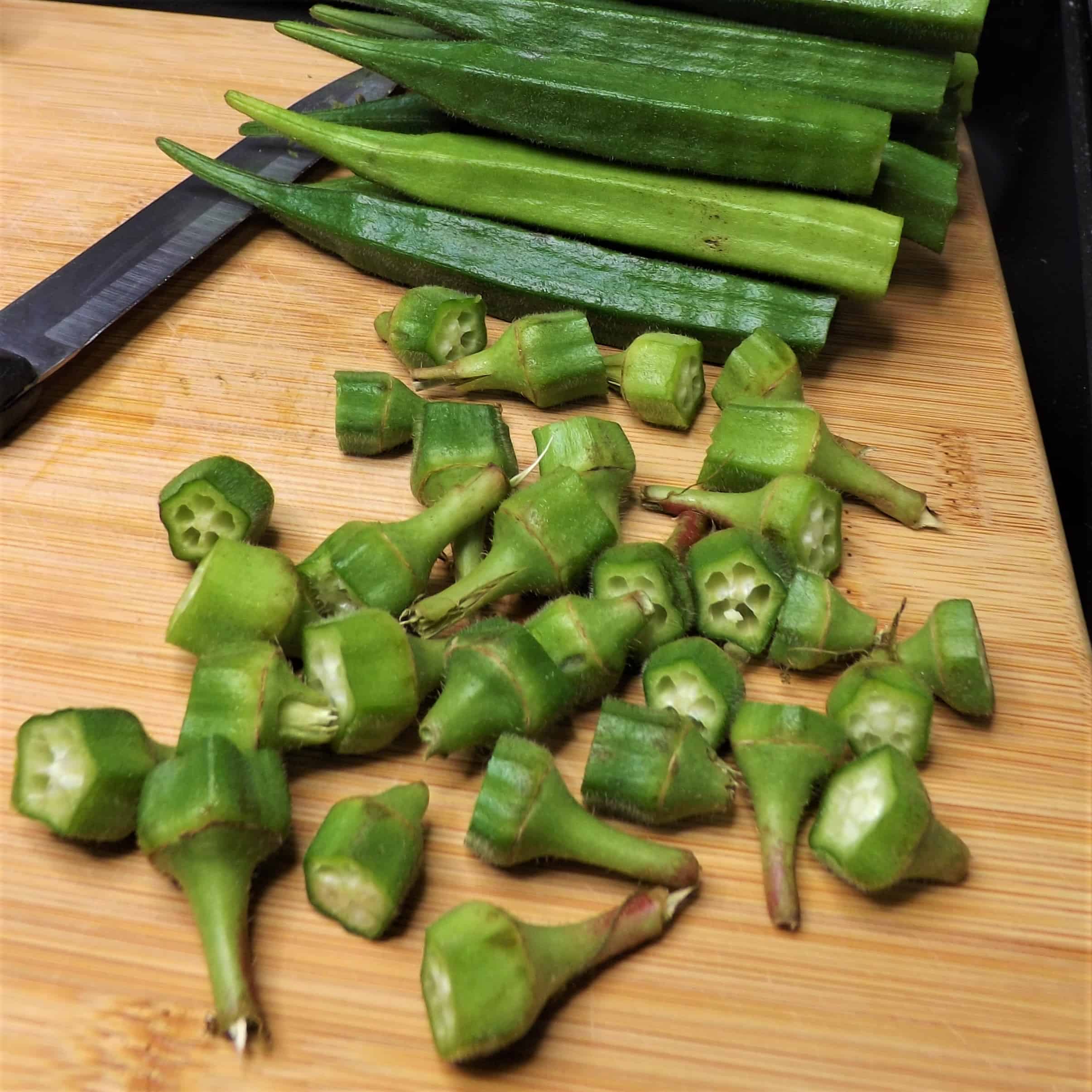 fresh cut okra on cutting board