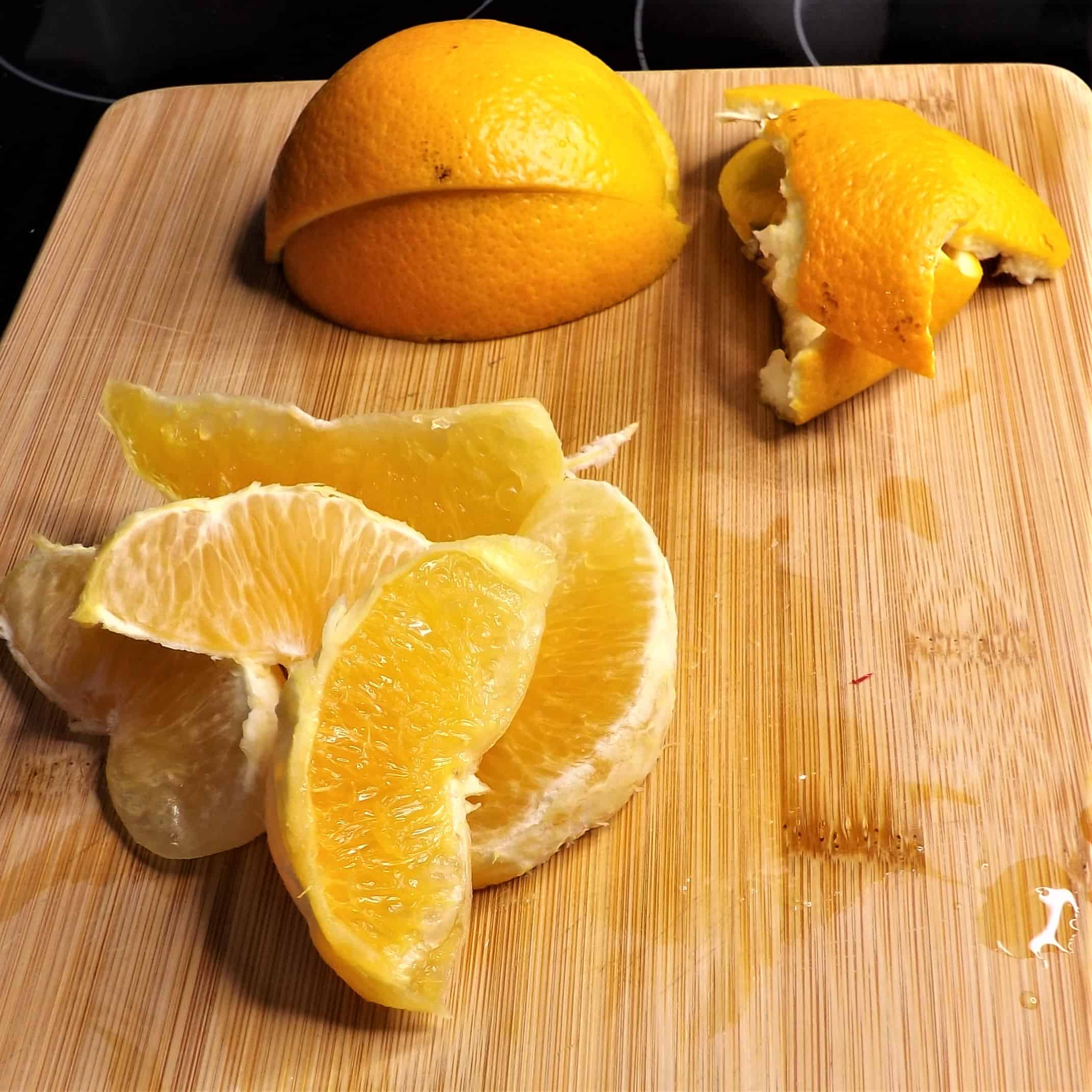fresh cut oranges on cutting board