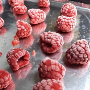 frozen raspberries on baking pan wrapped in foil