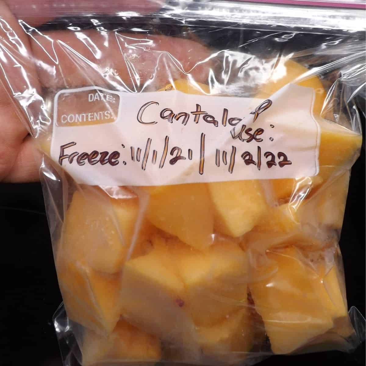 Chunks of cantaloupe in a freezer bag.